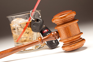 Car keys with gavel and alcoholic drink